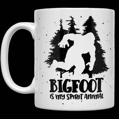 White mug with a black silhouette of Bigfoot and trees, and 'BIGFOOT is my spirit animal' text.
