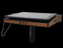 Tablet stand with 'SLS X' branding on a black background