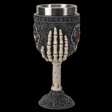 Decorative goblet with skeleton hand design on a black background