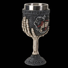 Decorative goblet with skull design on a black background