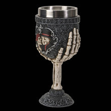 Decorative goblet with skull design on a black background