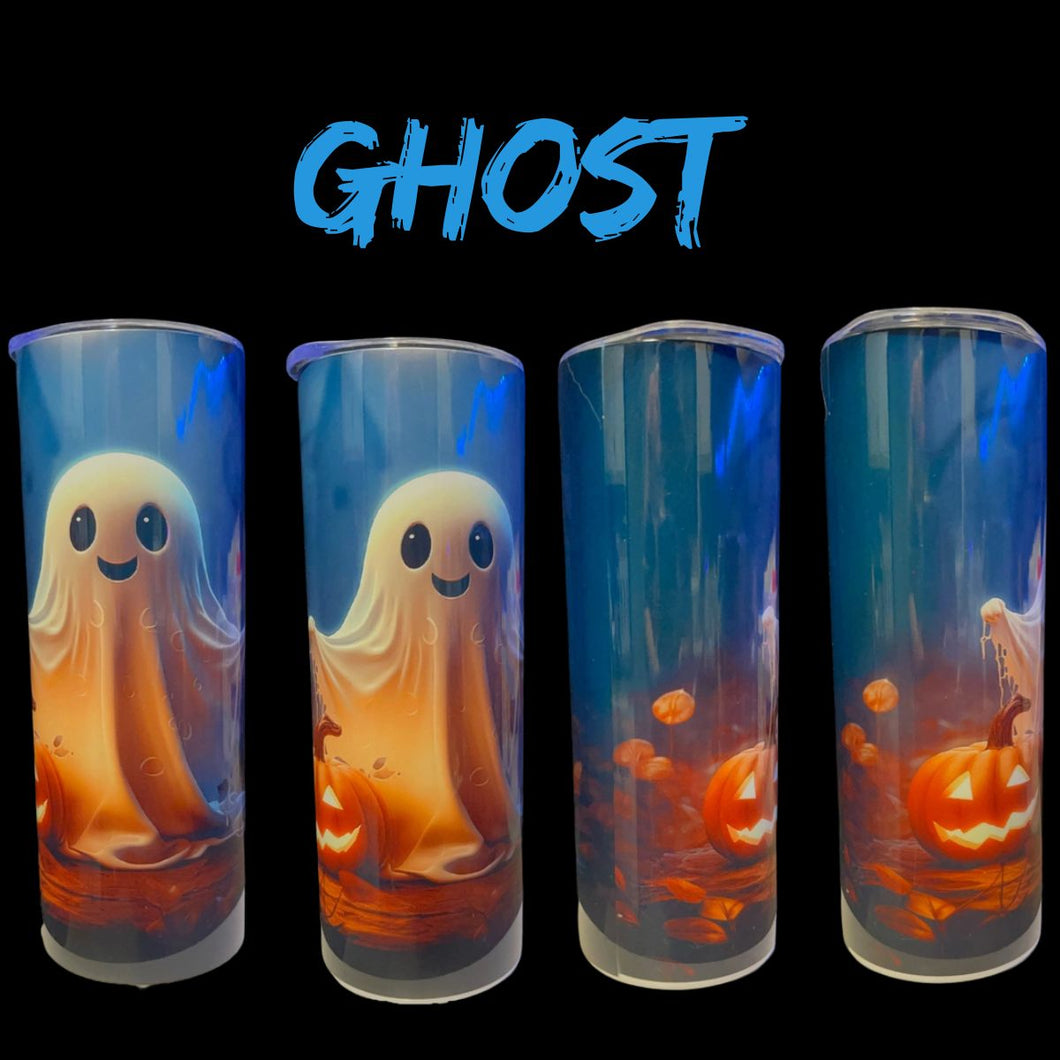Four tall cylindrical tumblers with clear lids, featuring a Halloween design with a smiling orange ghost, jack-o'-lanterns, and a blue glowing background. The word 'GHOST' is written in blue brush-style text above the tumblers on a black background.