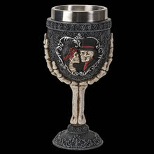 Decorative goblet with skull and rose design on a black background